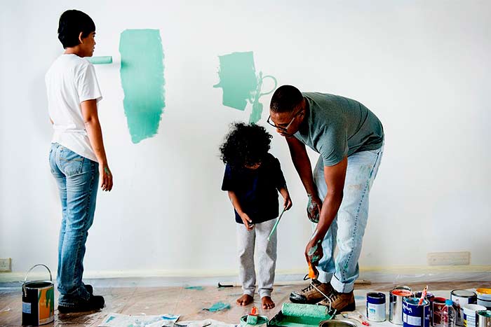 Family painting a wall