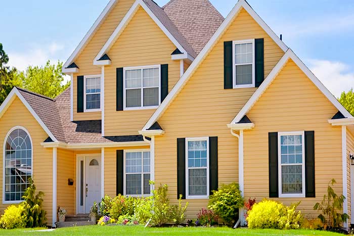 What cost factors are there with vinyl siding yellow siding house