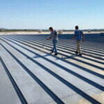 applying primer to metal roof