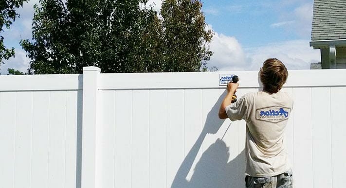 contractor installing a vinyl fence