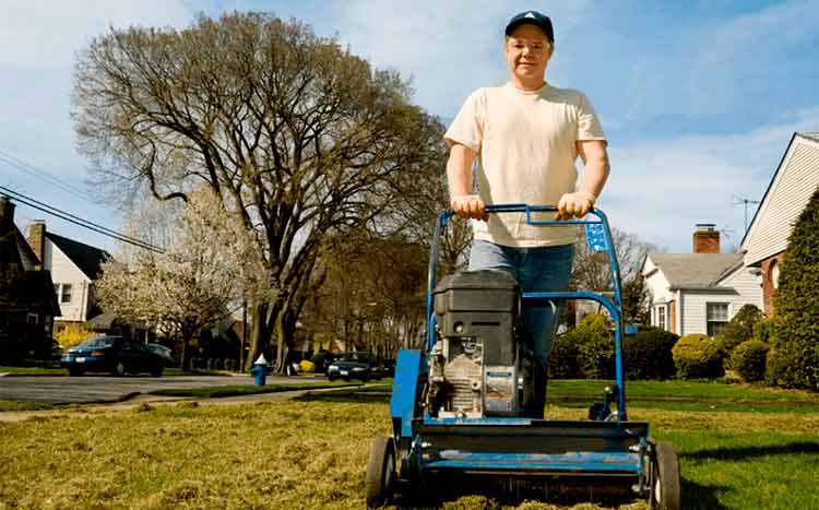 Hiring lawn aeration companies in my area man aerat the lawn