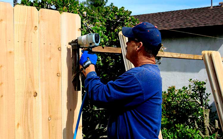 Can my neighbor build a fence on the property line man install the fence