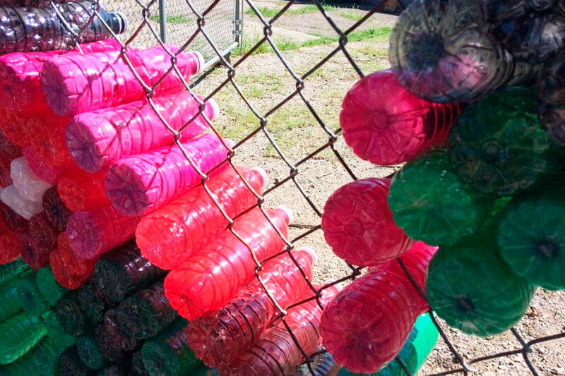 Insert Bottles In The Chain Link Fence