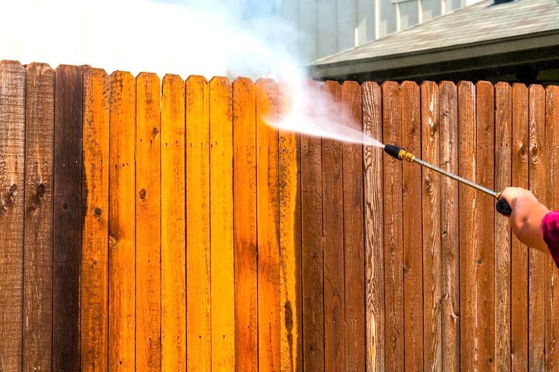 Step 4 Clean your wood fence with long and even strokes