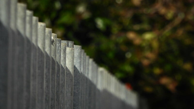 Corrugated metal fence